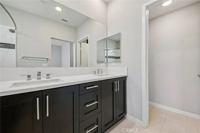 a bathroom with a shower sink and mirror