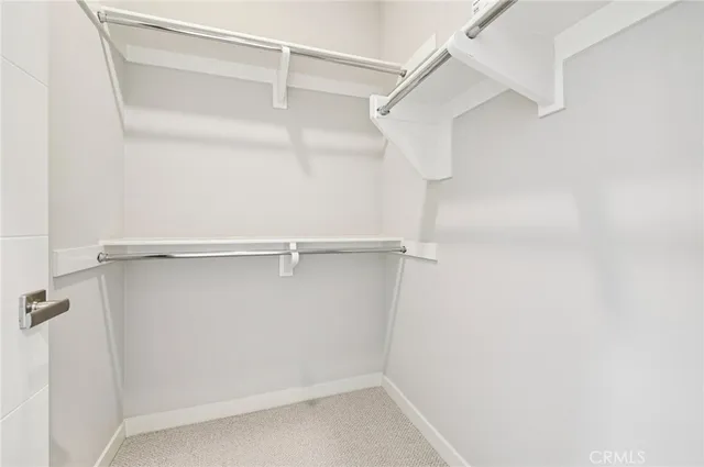 an empty room with windows and ceiling fan