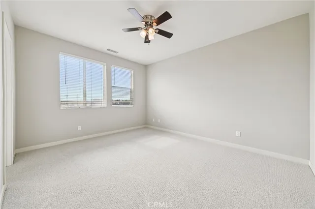 a view of a hallway with wooden cabinets