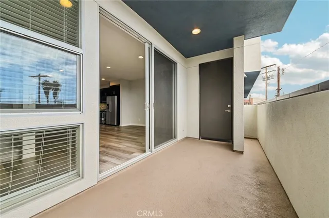 a view of a chairs and table in the balcony