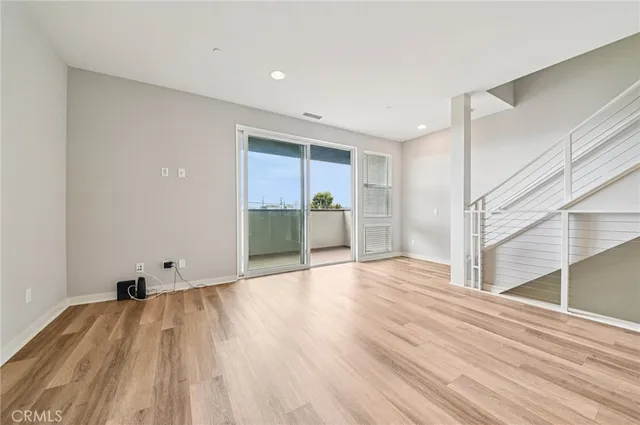 a view of kitchen with refrigerator and window