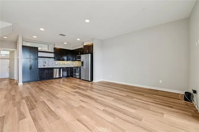 a kitchen with stainless steel appliances granite countertop a refrigerator and a stove