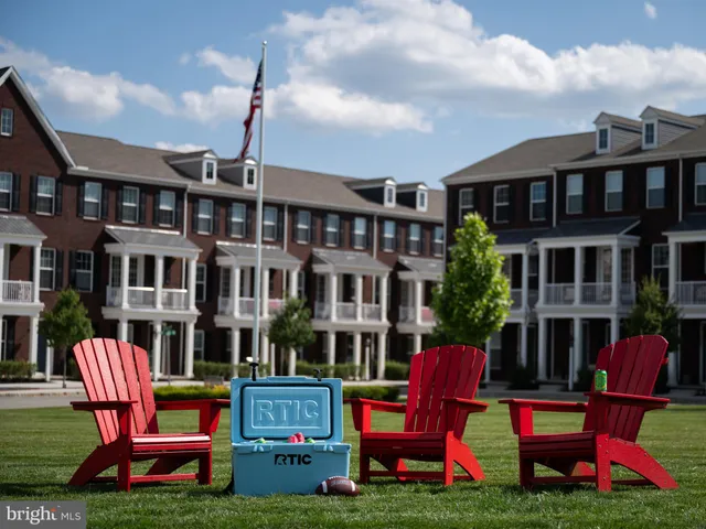 a backyard of a house with barbeque oven table and chairs