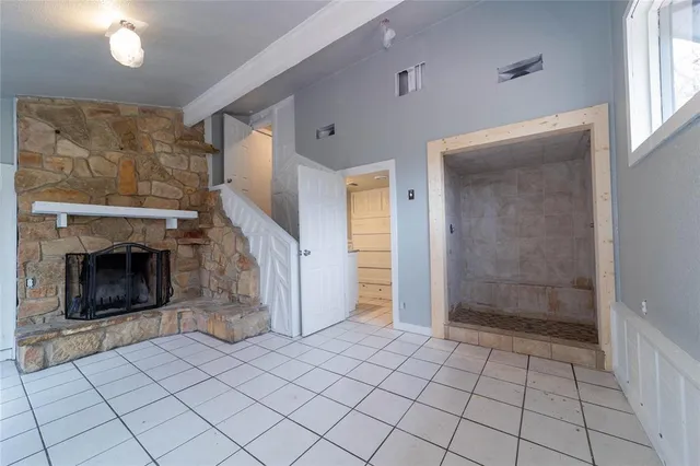 a view of an empty room and fire place