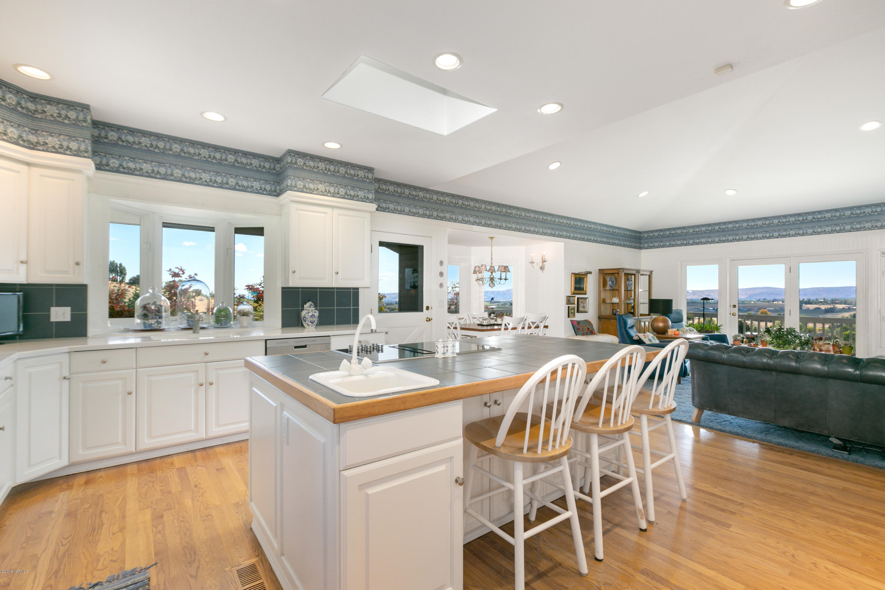 14771 Summitview Ext Road Yakima, WA 98908 - Photo 12 of 45 a kitchen with a dining table chairs sink and white cabinets