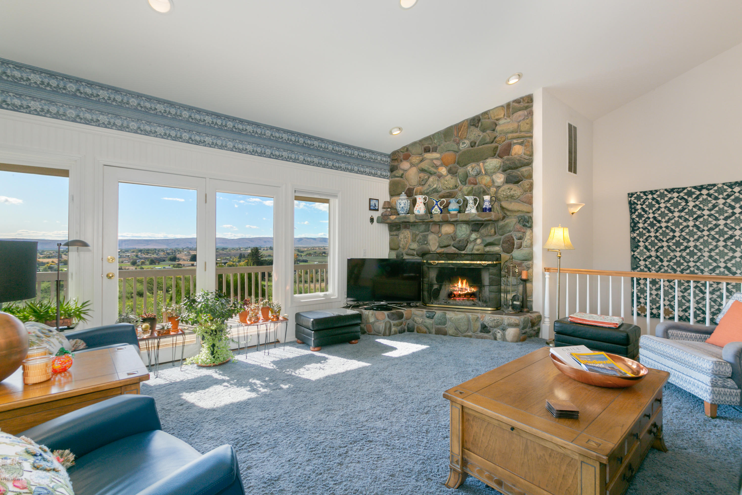 14771 Summitview Ext Road Yakima, WA 98908 - Photo 14 of 45 a living room with furniture a fireplace and a floor to ceiling window
