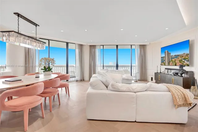 a living room with furniture a dining table and chairs