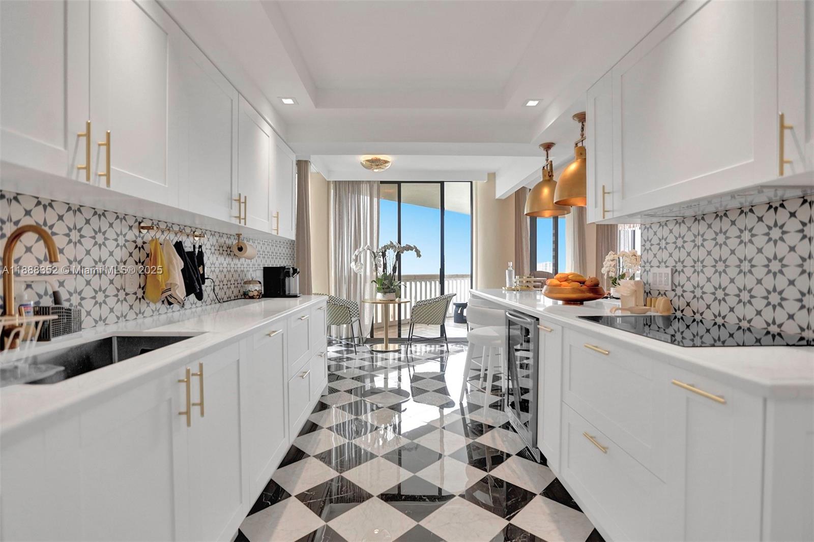2000 Island Boulevard, Unit 2207 Aventura, FL 33160 - Photo 14 of 29 a kitchen with stainless steel appliances a sink a stove a refrigerator and cabinets