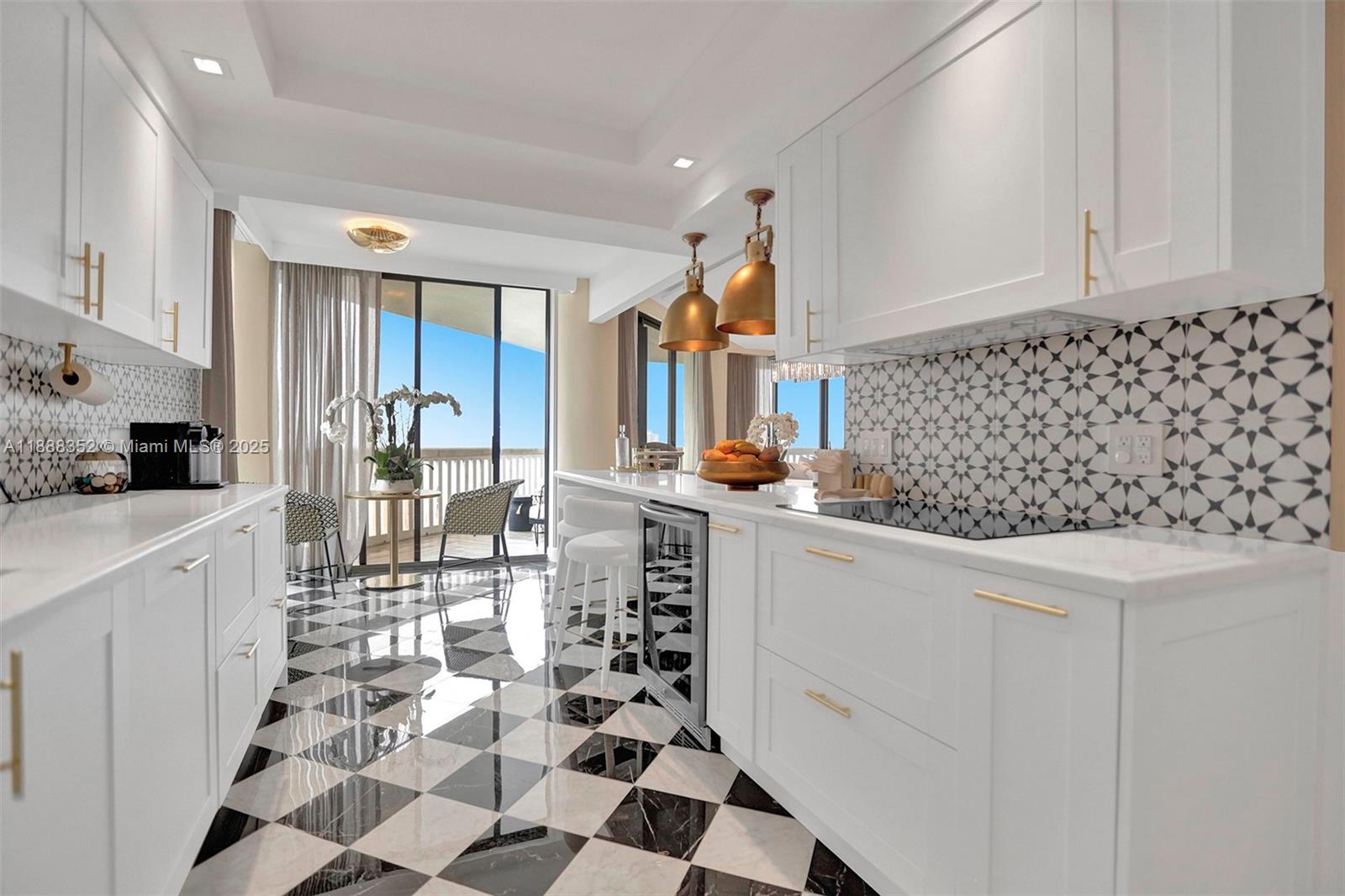 2000 Island Boulevard, Unit 2207 Aventura, FL 33160 - Photo 15 of 29 a kitchen with white cabinets and appliances