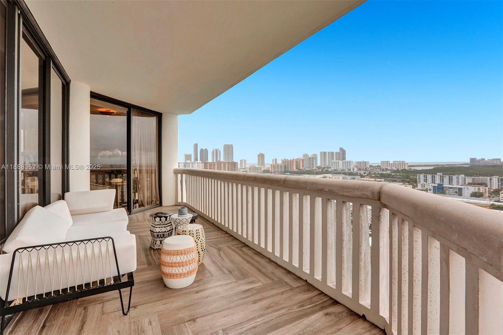 2000 Island Boulevard, Unit 2207 Aventura, FL 33160 - Photo 18 of 29 a balcony with chairs and wooden floor