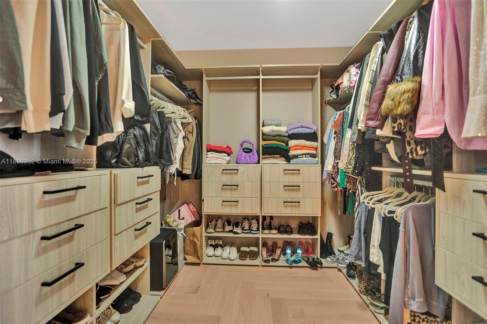 2000 Island Boulevard, Unit 2207 Aventura, FL 33160 - Photo 20 of 29 a view of walk in closet with clothes and shoes