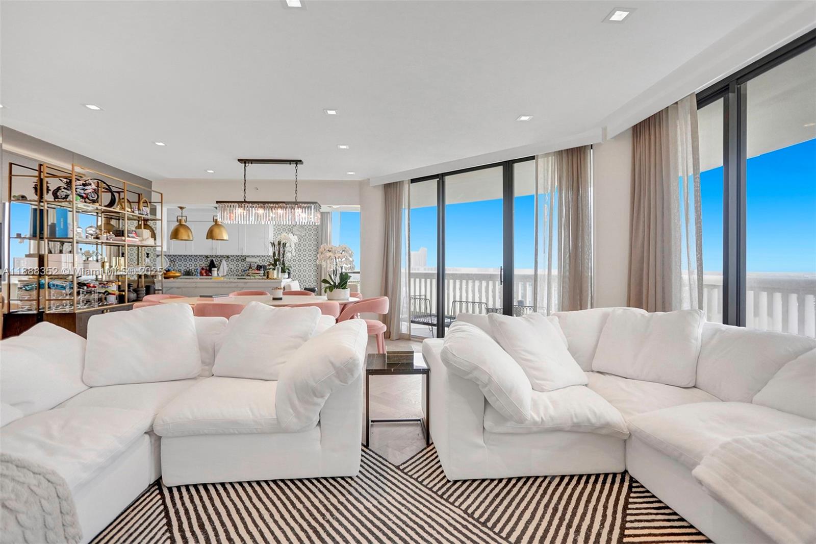 2000 Island Boulevard, Unit 2207 Aventura, FL 33160 - Photo 23 of 29 a living room with furniture a rug and a chandelier