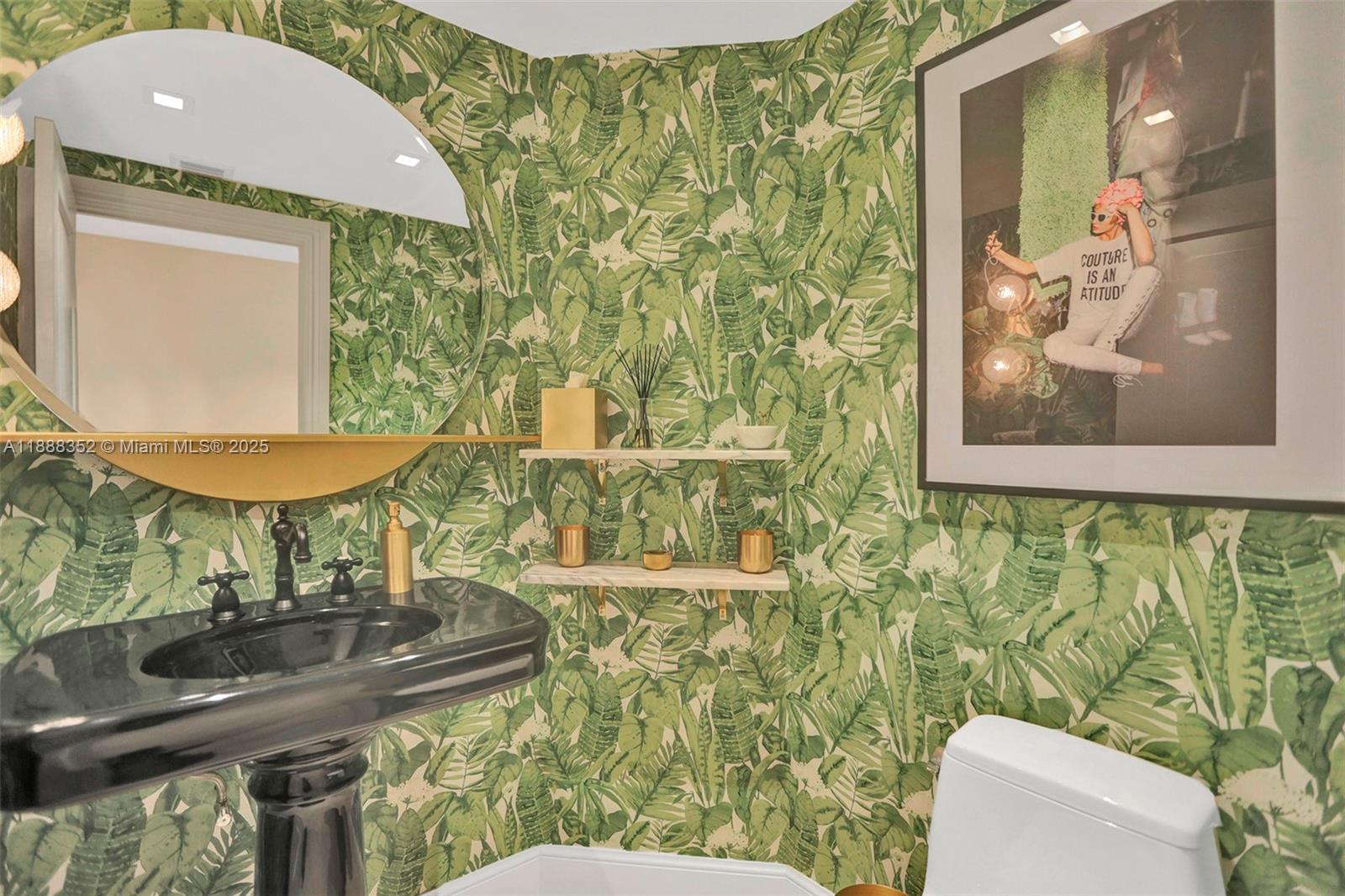 2000 Island Boulevard, Unit 2207 Aventura, FL 33160 - Photo 8 of 29 a bathroom with a toilet sink and mirror