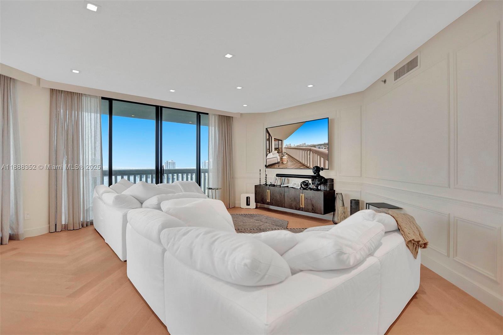 2000 Island Boulevard, Unit 2207 Aventura, FL 33160 - Photo 10 of 29 a living room with furniture and a flat screen tv