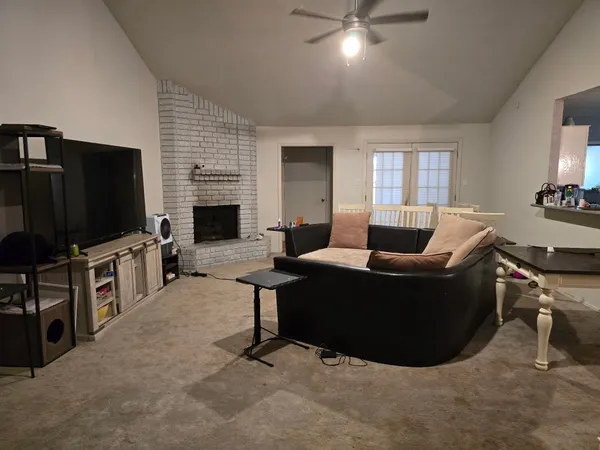 a living room with furniture and a flat screen tv