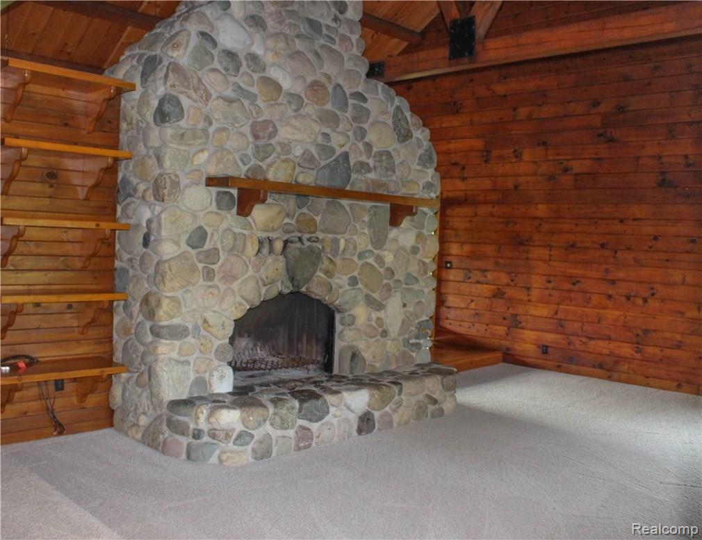 4165 Morgan Road Lake Orion, MI 48359 - Photo 29 of 81 Natural field stone fireplace from floor to vaulted ceiling. What a perfect fall scene.