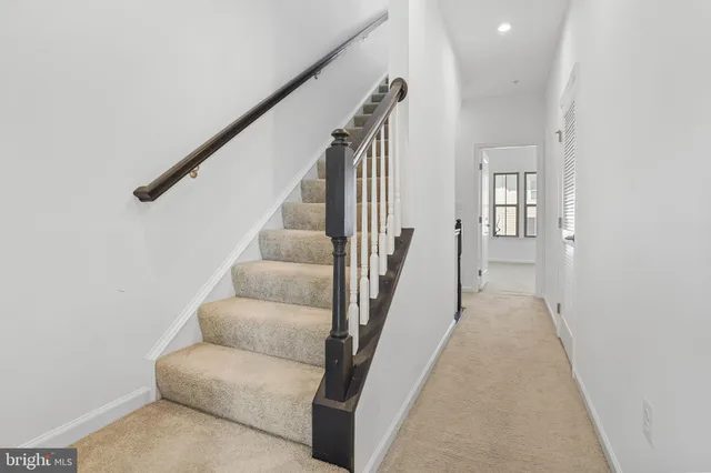 a bedroom with a bed and painting on the wall