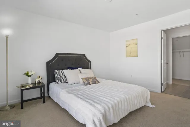 a bedroom with a large bed and a large window