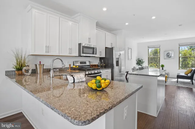 a kitchen with sink stove and cabinets