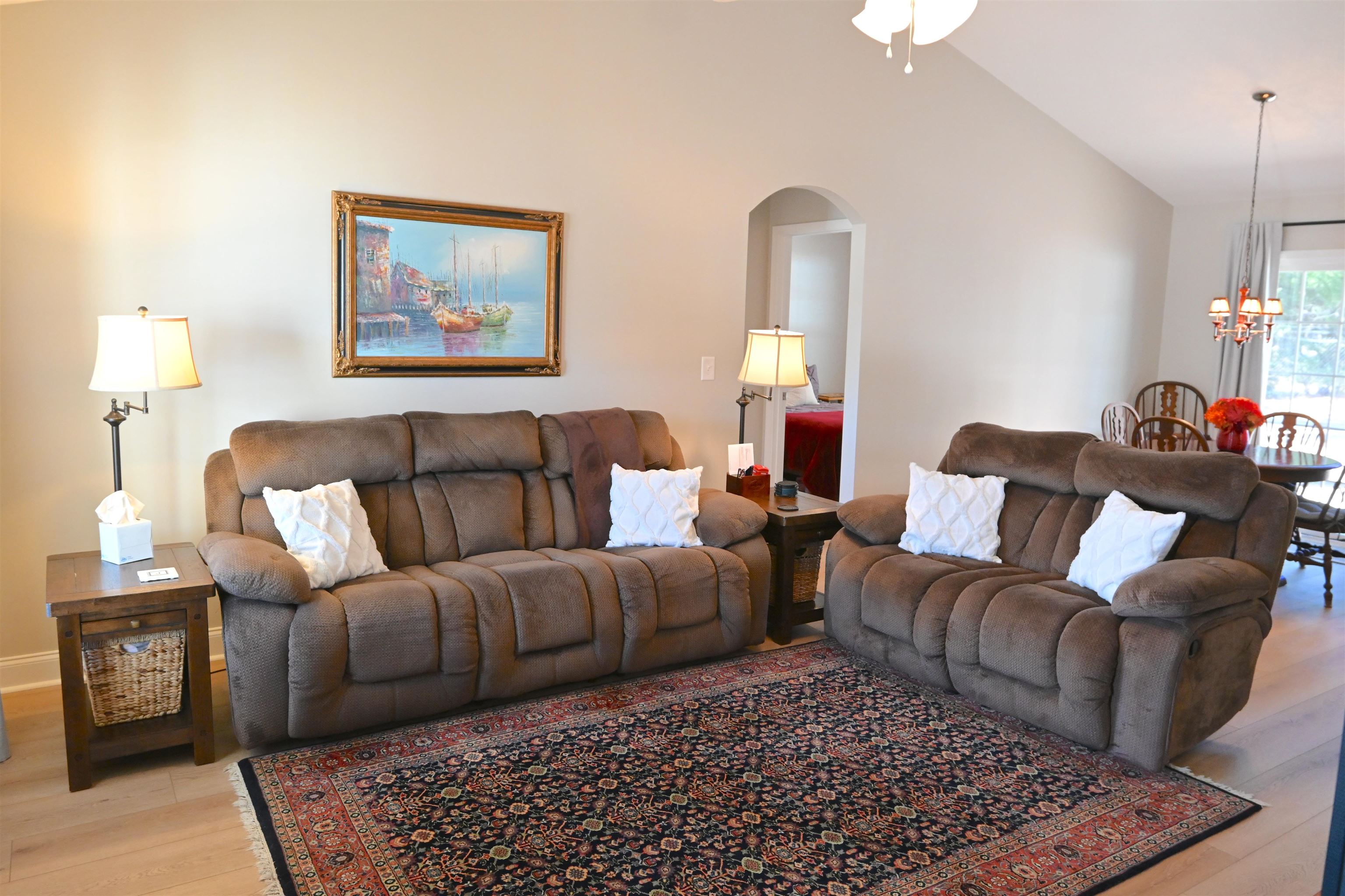 233 Macarthur Drive Conway, SC 29527 - Photo 3 of 21 Living room with light wood-type flooring, arched walkways, vaulted ceiling, a chandelier, and a ceiling fan
