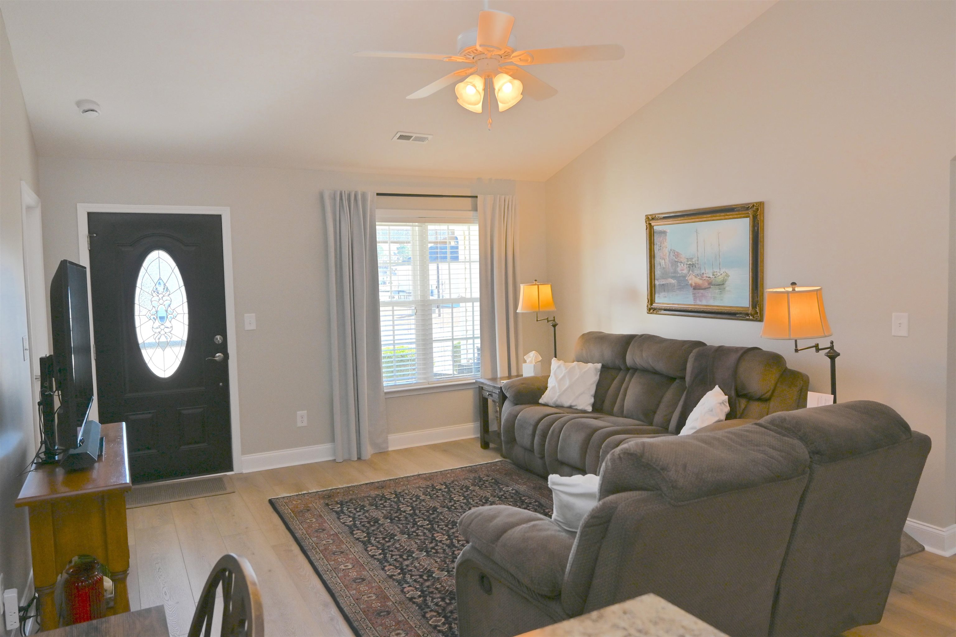 233 Macarthur Drive Conway, SC 29527 - Photo 4 of 21 Living room featuring light wood-style flooring, vaulted ceiling, and a ceiling fan