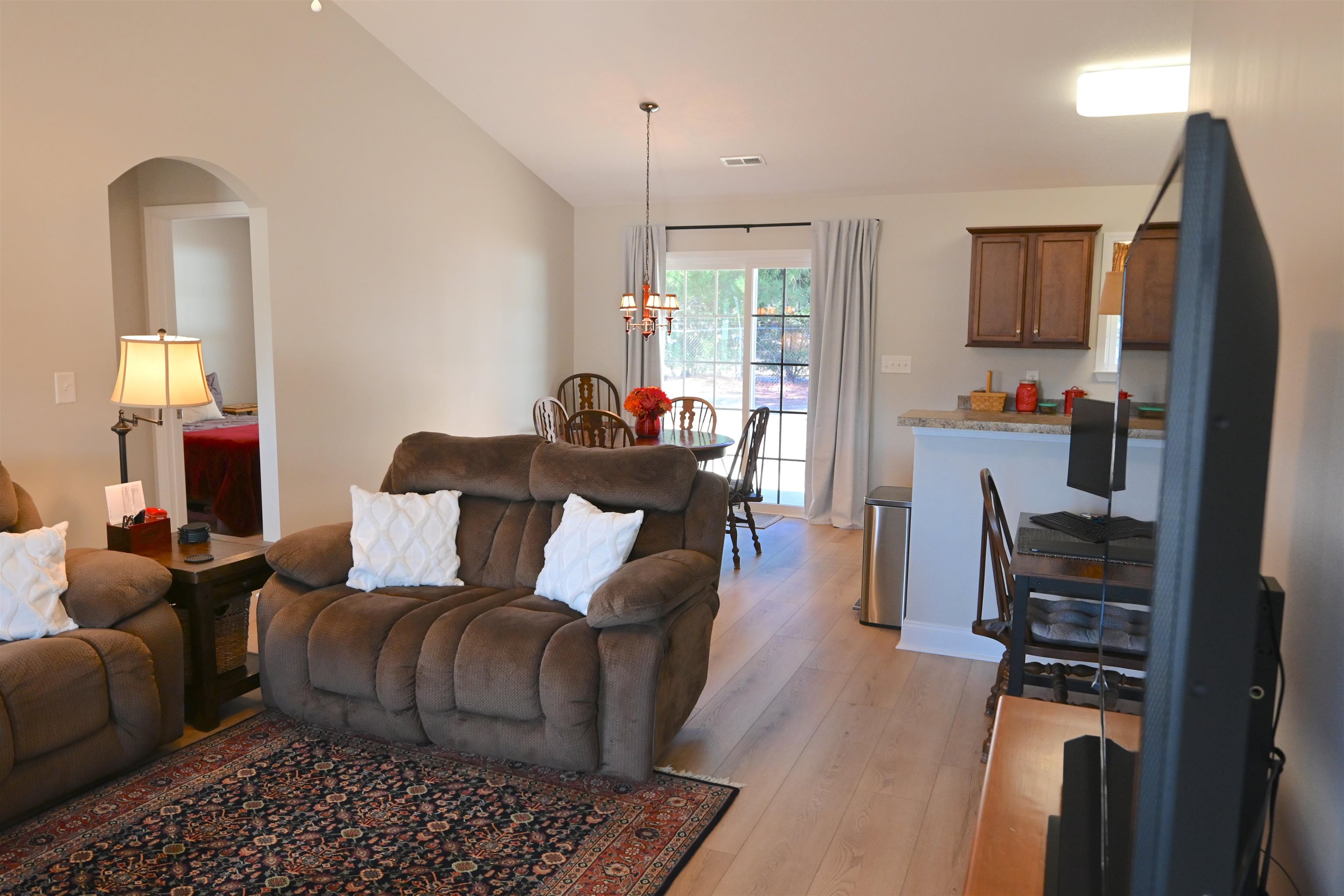 233 Macarthur Drive Conway, SC 29527 - Photo 6 of 21 Living area with light wood-style floors, lofted ceiling, arched walkways, and a chandelier