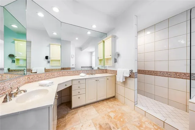 a bathroom with a sink toilet vanity and shower