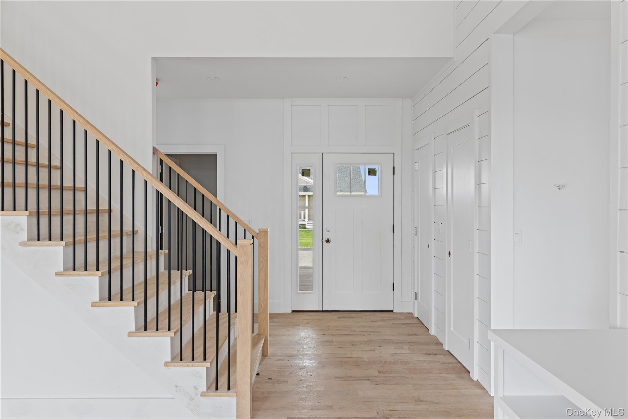 74 Tyler Drive Riverhead, NY 11901 - Photo 13 of 23 Entrance foyer featuring wood finished floors and stairs