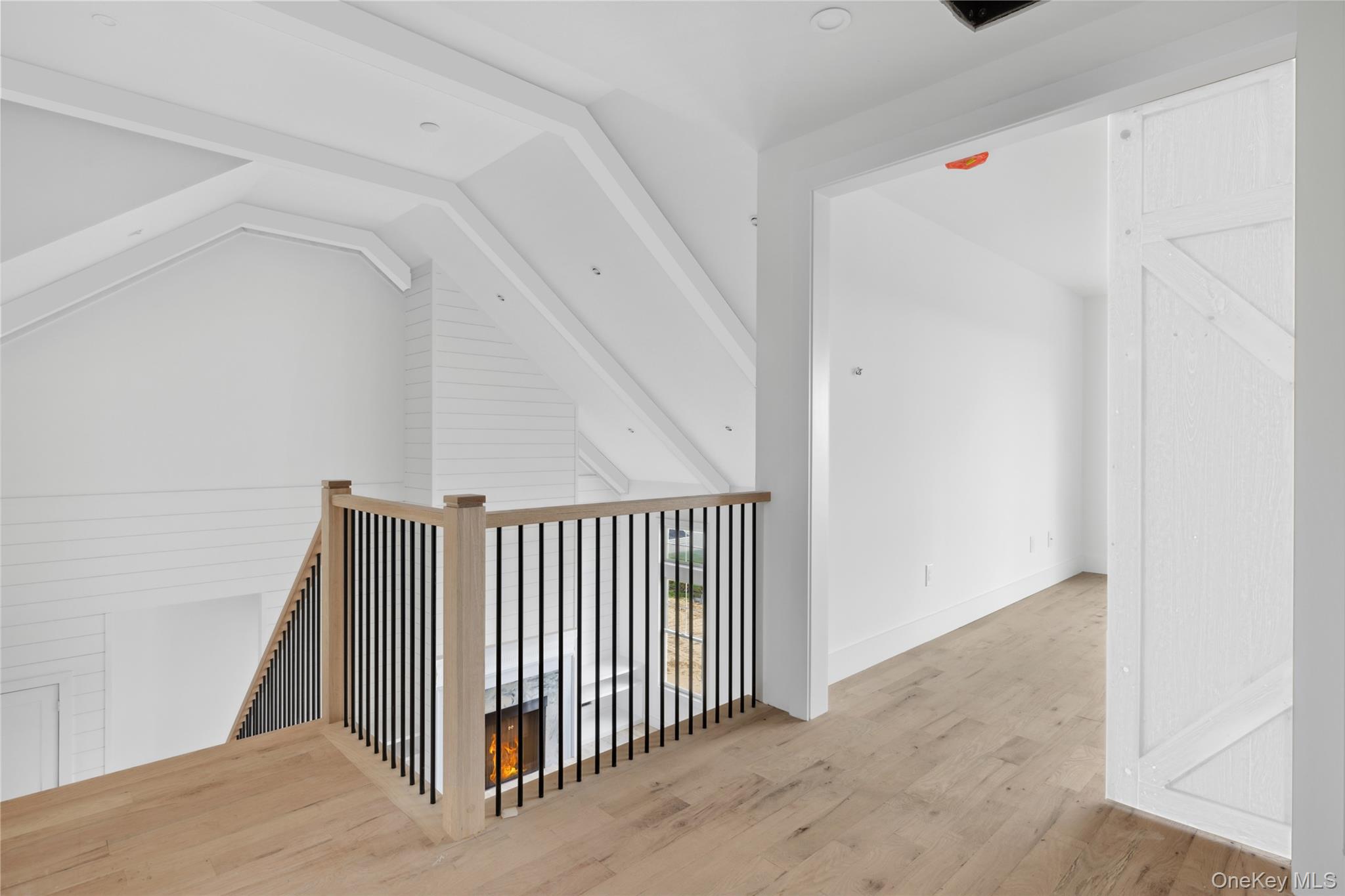 74 Tyler Drive Riverhead, NY 11901 - Photo 14 of 23 Hallway featuring an upstairs landing, vaulted ceiling, wood finished floors, and baseboards
