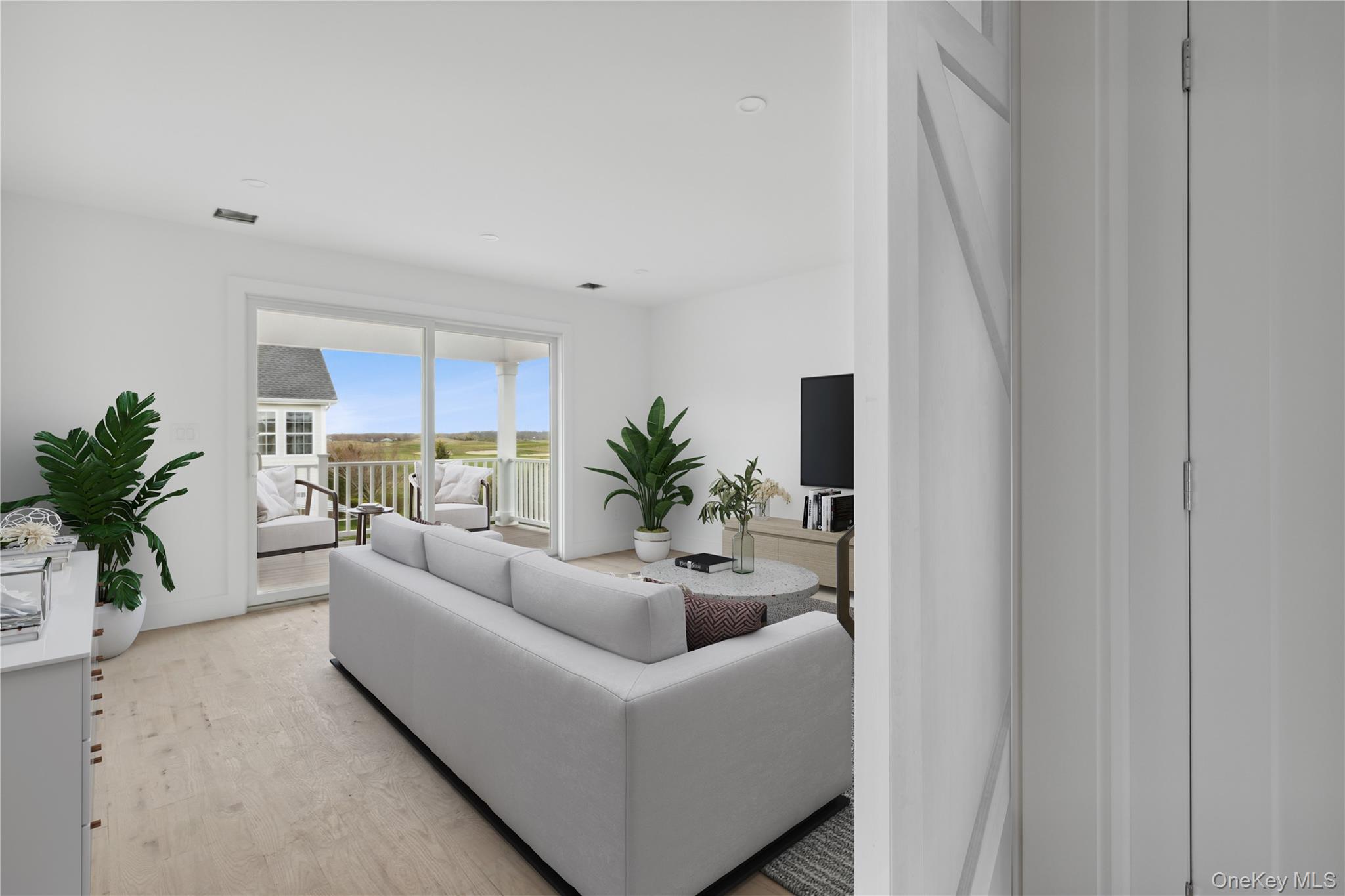 74 Tyler Drive Riverhead, NY 11901 - Photo 16 of 23 Living room with light wood finished floors and visible vents
