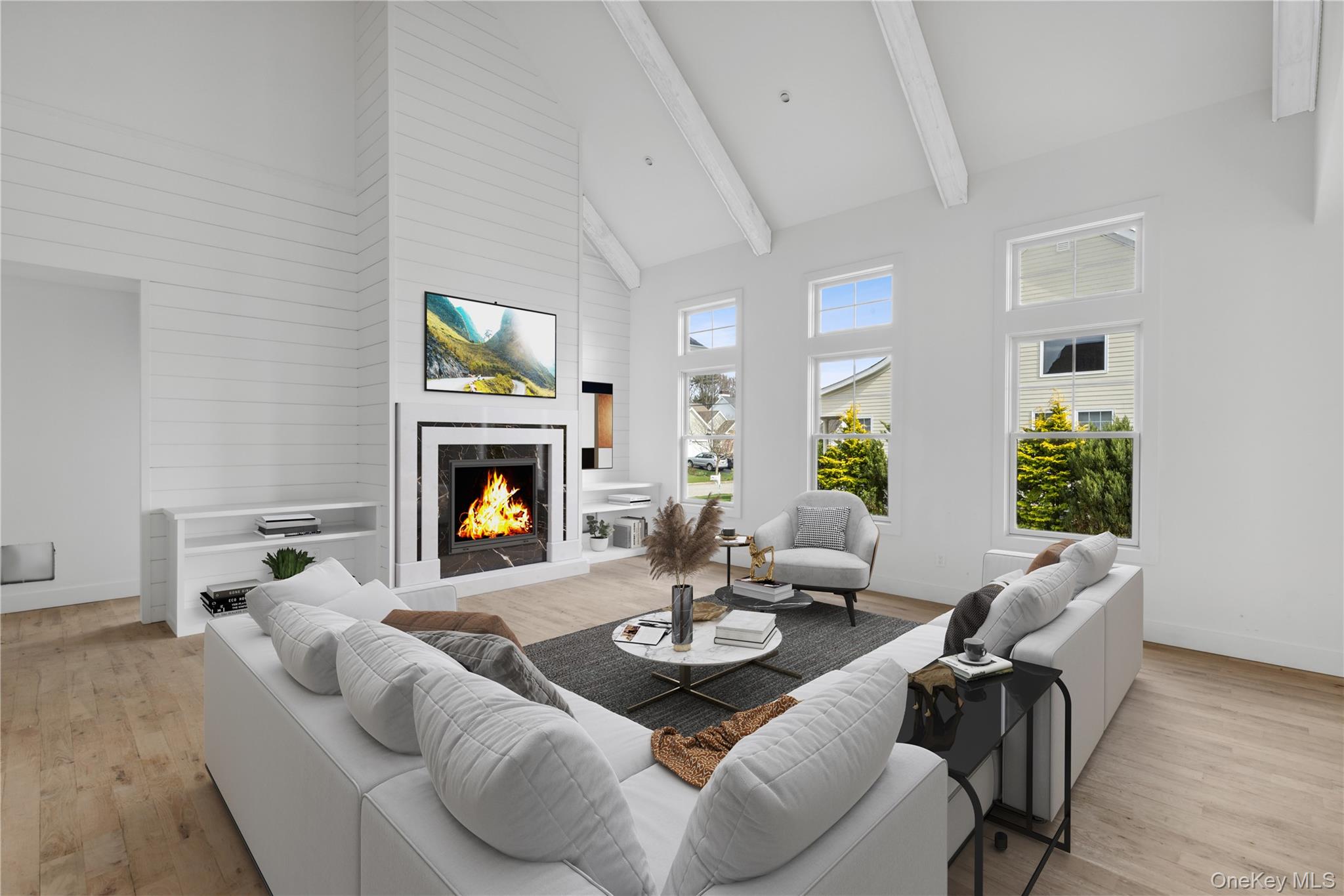 74 Tyler Drive Riverhead, NY 11901 - Photo 4 of 23 Living room with high vaulted ceiling, a high end fireplace, light wood finished floors, beamed ceiling, and baseboards