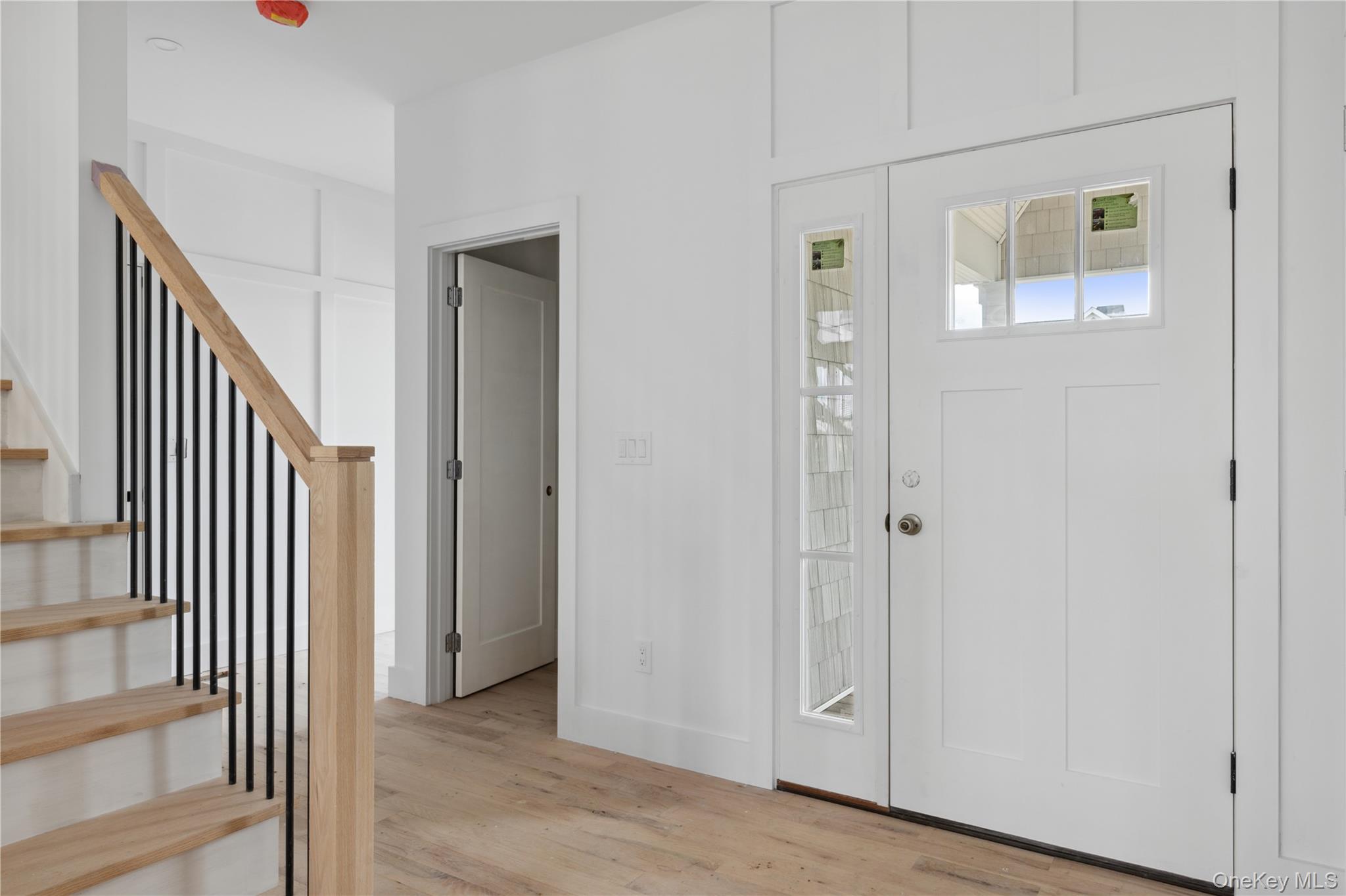 74 Tyler Drive Riverhead, NY 11901 - Photo 9 of 23 Entrance foyer with light wood-type flooring, baseboards, and stairway