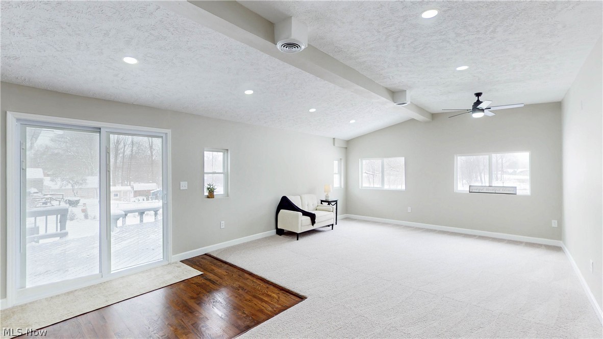 3312 Bancroft Road Akron, OH 44333 - Photo 12 of 50 Unfurnished room featuring beamed ceiling, light wood-style floors, a textured ceiling, recessed lighting, and ceiling fan