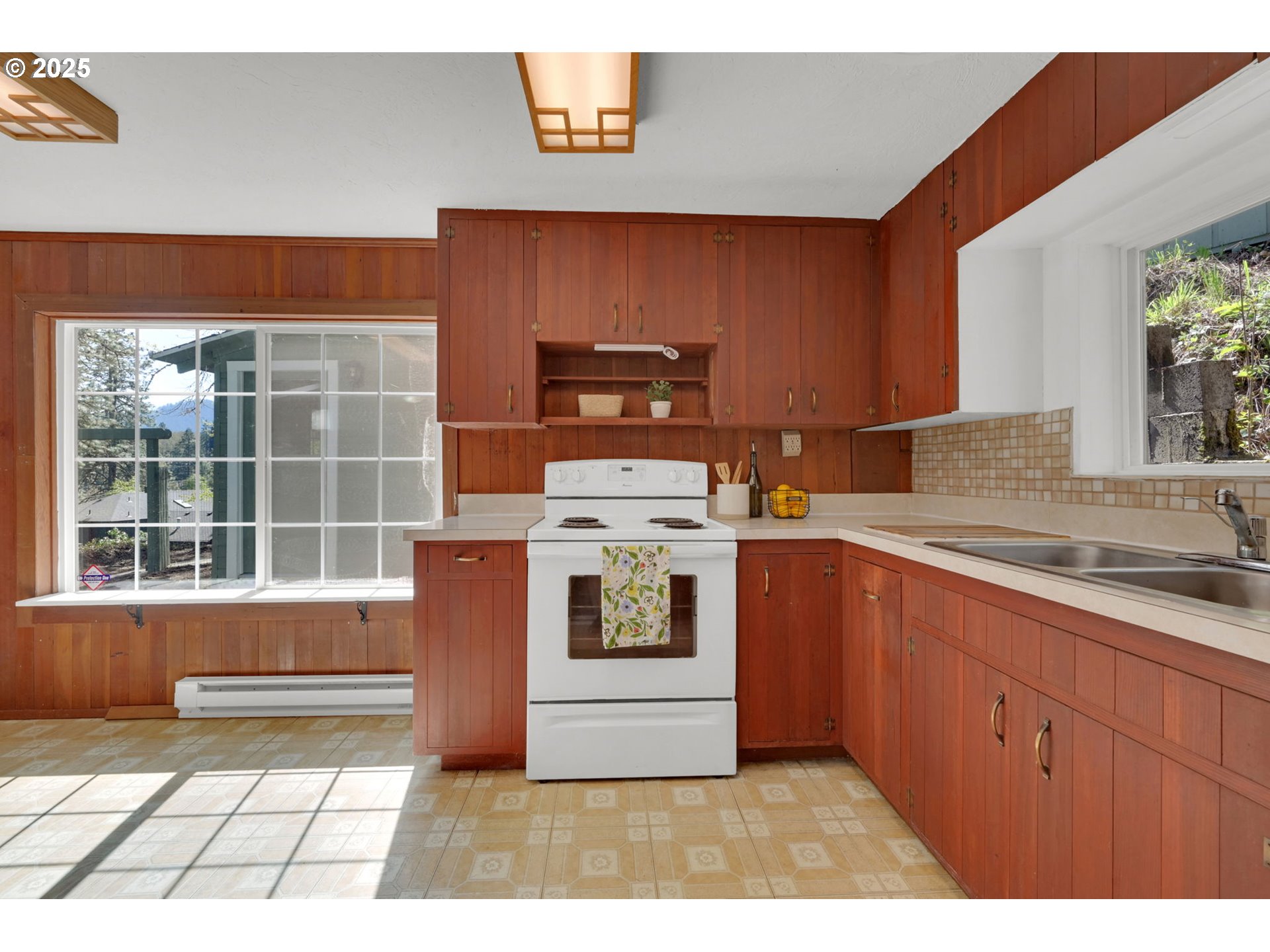 22 Prall Lane Eugene, OR 97405 - Photo 11 of 43 a kitchen with stainless steel appliances granite countertop a stove a sink and a microwave