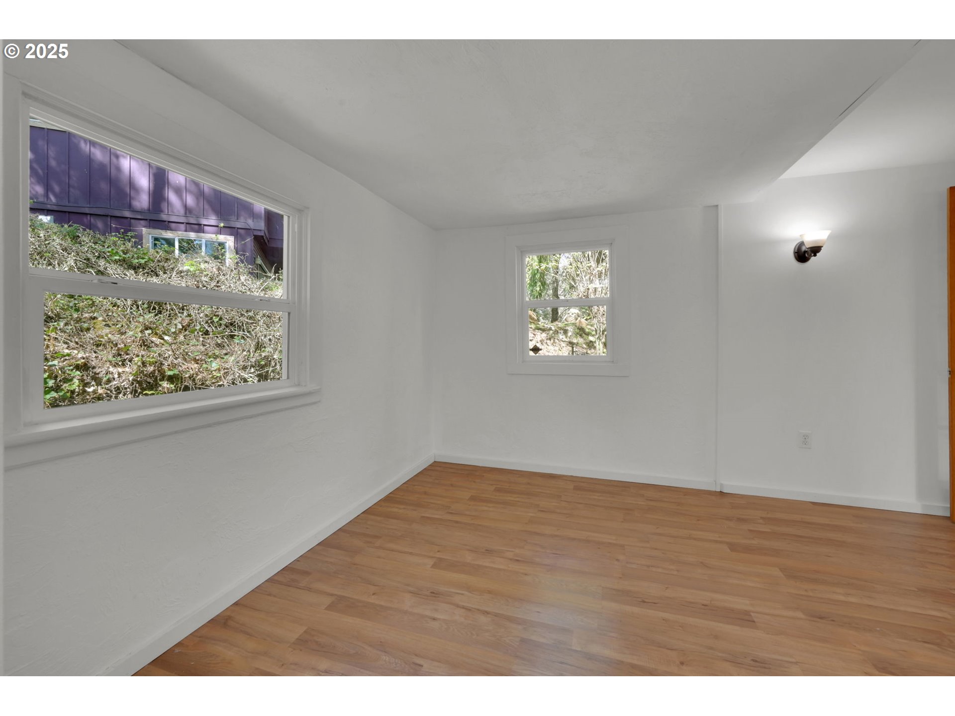 22 Prall Lane Eugene, OR 97405 - Photo 20 of 43 a view of an empty room with window and wooden floor