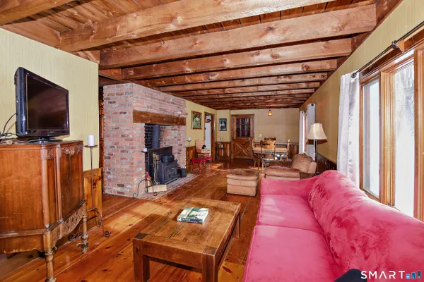 a view of a livingroom with furniture and a flat screen tv