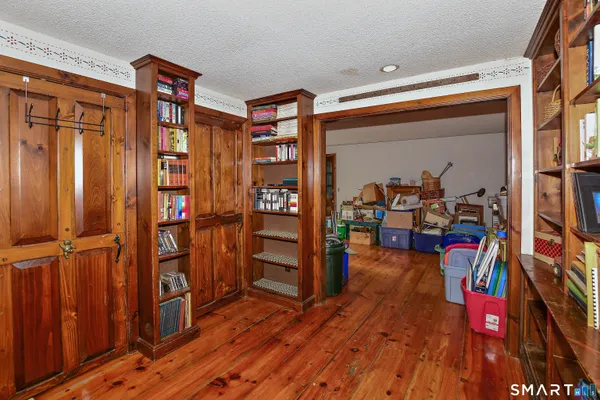 an empty room with wooden floor and furniture