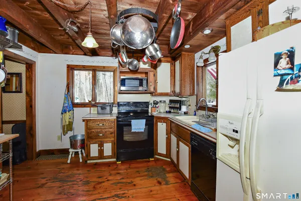 a kitchen with stainless steel appliances granite countertop a stove cabinets and a dining table