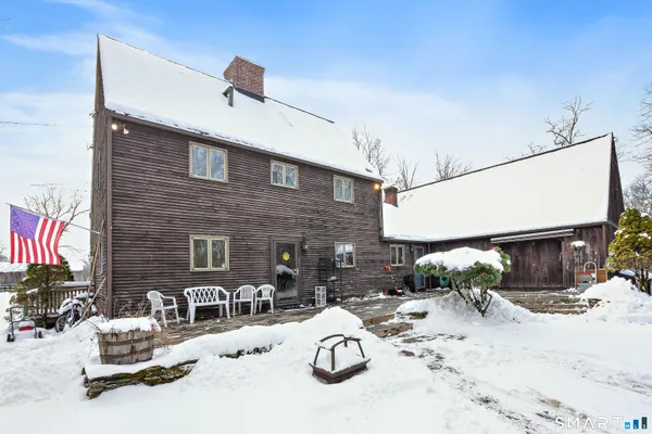 a building outdoor space with patio furniture and potted plants