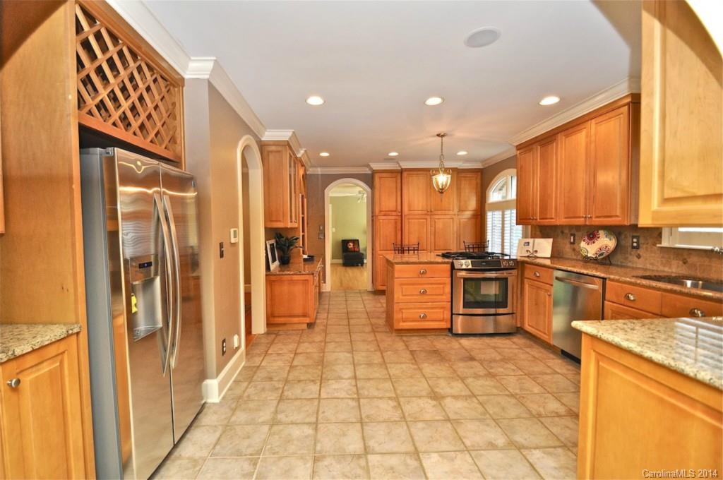 1931 Providence Road Charlotte, NC 28211 - Photo 11 of 22 a large kitchen with stainless steel appliances kitchen island granite countertop a refrigerator and a stove