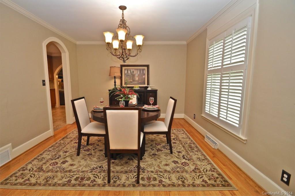 1931 Providence Road Charlotte, NC 28211 - Photo 12 of 22 a view of a dining room with furniture a rug and wooden floor