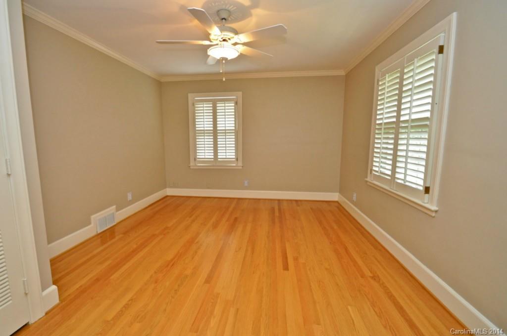 1931 Providence Road Charlotte, NC 28211 - Photo 21 of 22 a view of an empty room with wooden floor and a window