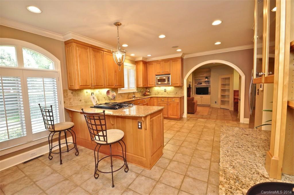 1931 Providence Road Charlotte, NC 28211 - Photo 10 of 22 a kitchen with stainless steel appliances granite countertop a sink and a refrigerator