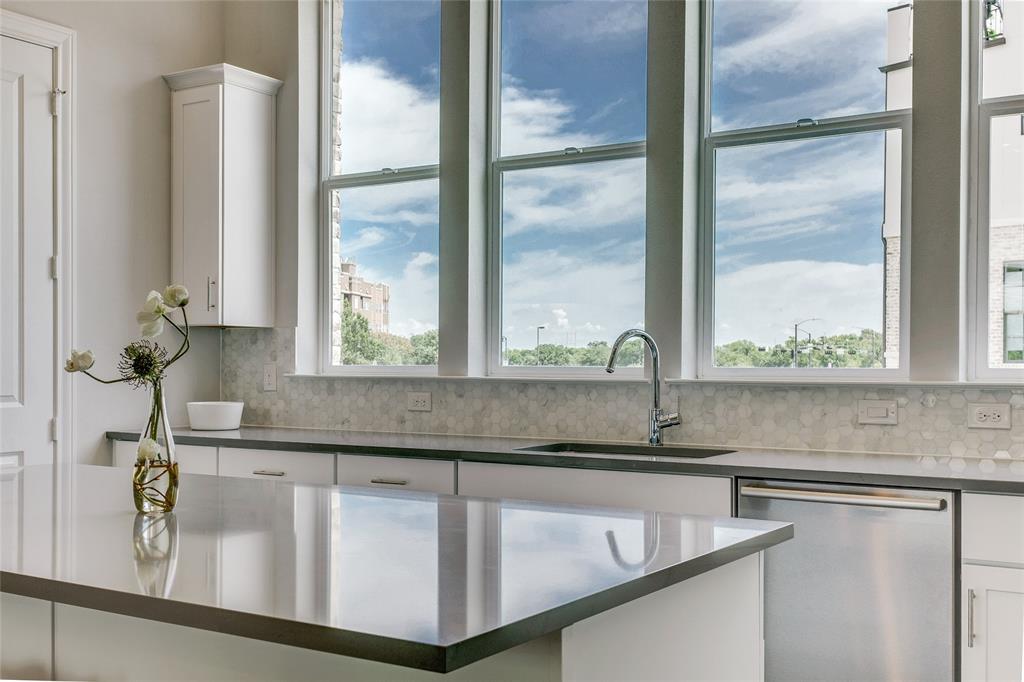 a bathroom with a granite countertop sink and a window
