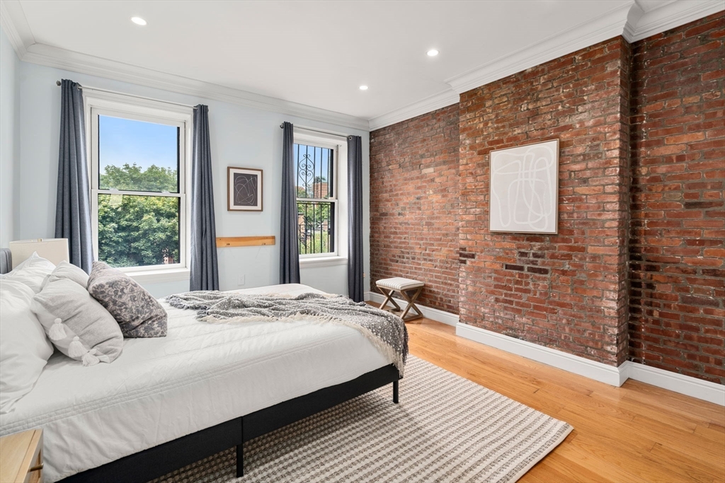 82 Berkeley Street, Unit 5 Boston, MA 02116 - Photo 21 of 31 a bedroom with a bed wooden floor and window