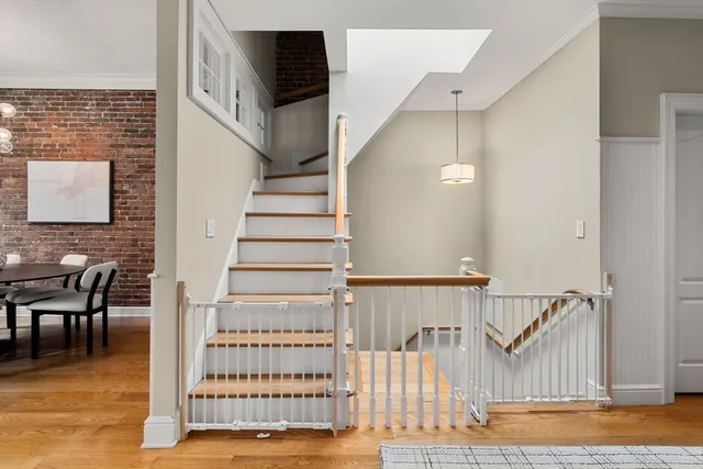 a view of entryway and hall with wooden floor