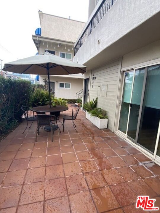 1908 Pacific Avenue Venice, CA 90291 - Photo 12 of 16 a view of a patio with table and chairs potted plants
