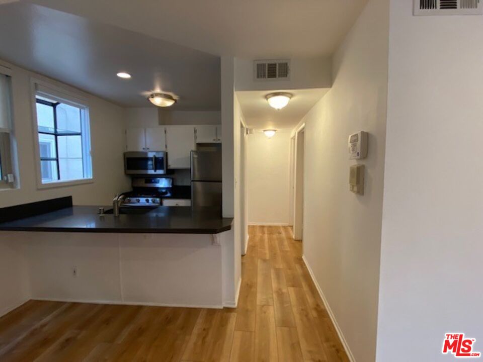 1908 Pacific Avenue Venice, CA 90291 - Photo 7 of 16 a kitchen with stainless steel appliances granite countertop a refrigerator and a stove top oven