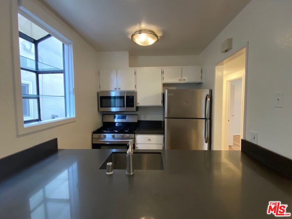 1908 Pacific Avenue Venice, CA 90291 - Photo 8 of 16 a kitchen with a refrigerator a stove and a window
