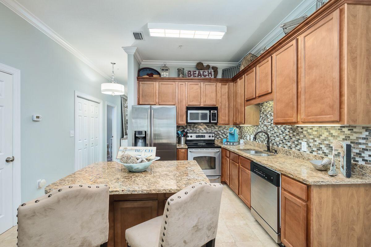 231 Somerset Bridge Road, Unit 2205 Santa Rosa Beach, FL 32459 - Photo 4 of 40 a kitchen with stainless steel appliances granite countertop a sink a stove and a refrigerator